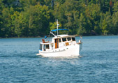 Boat on Lake George with trees in background