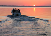 Boat driving into the sunset