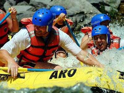 a group white water rafting and getting very wet