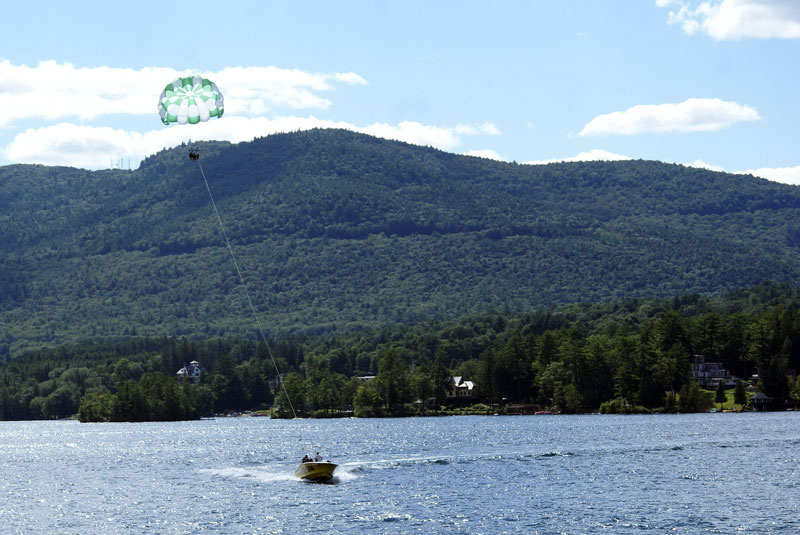 boat towing parasailers on lake george