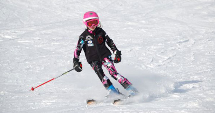 a girl skiing downhill