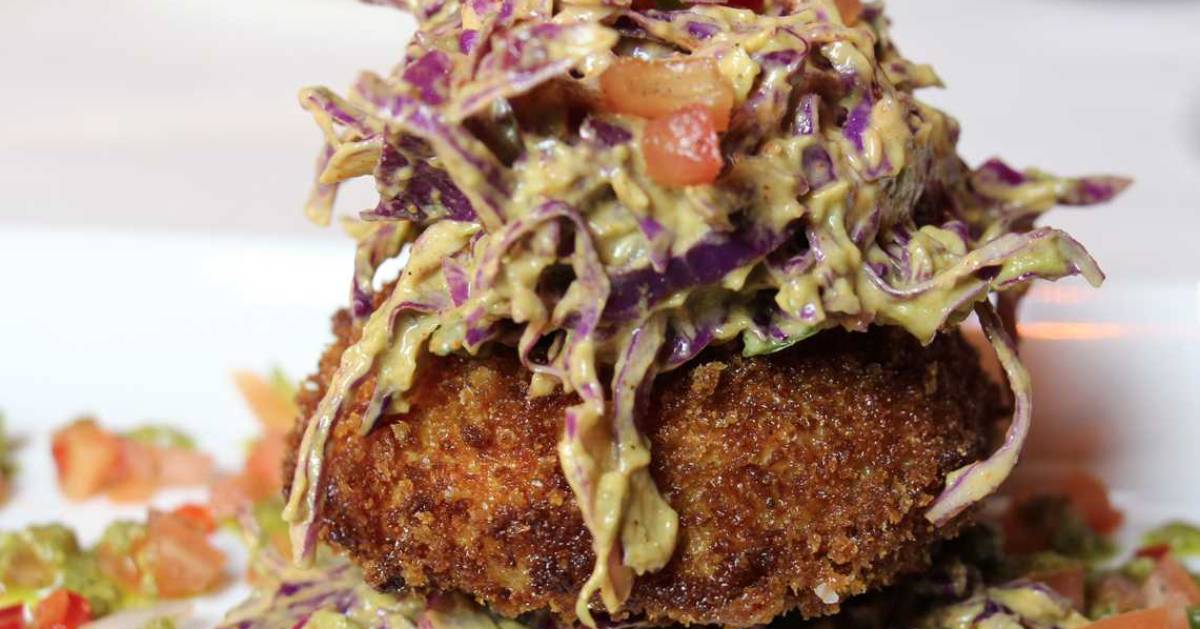 what looks like a crab cake topped with coleslaw