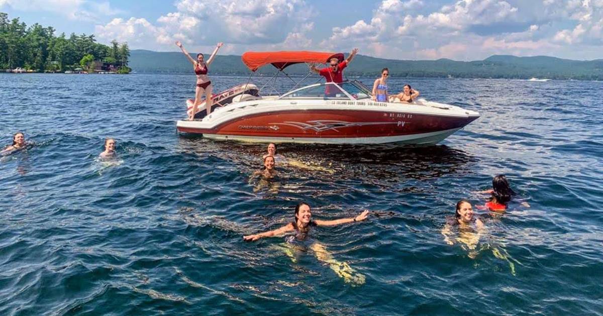 people swimming near a boat