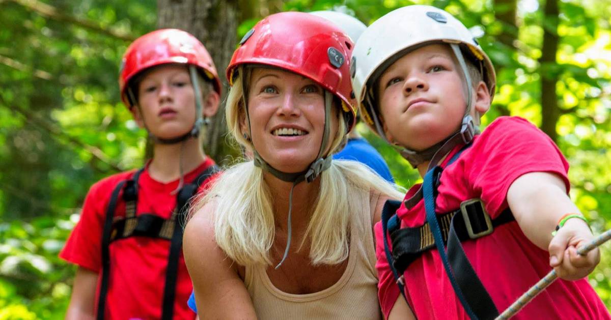 two campers and a counselor about to go on a ropes course