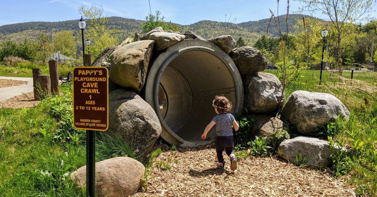 little girl going through cave crawl