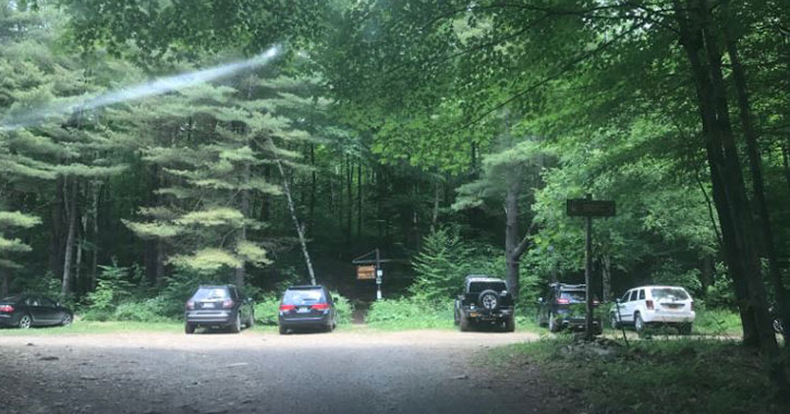 parking area with some cars at trailhead