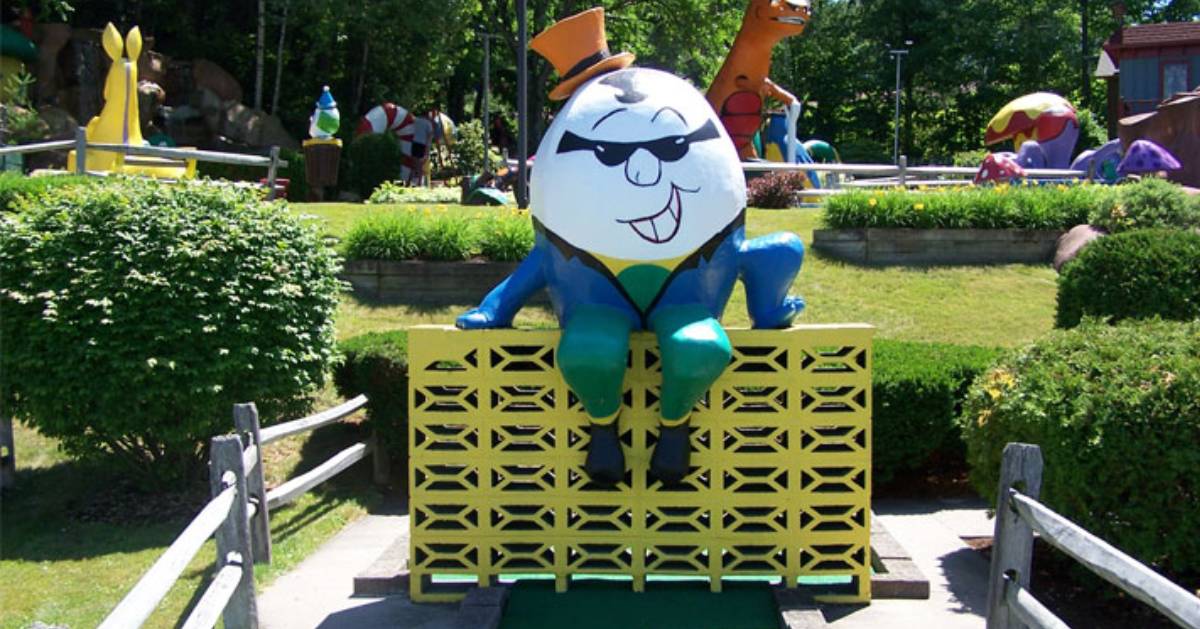 Humpy Dumpy sitting on a wall as part of a mini-golf course