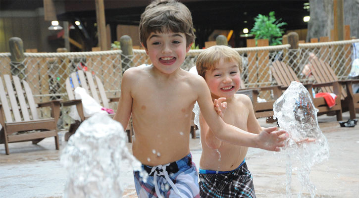 two little boys playing in the water park