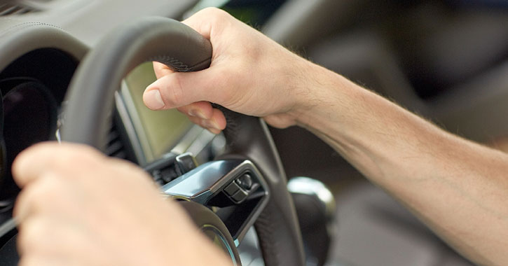 hans of person driving