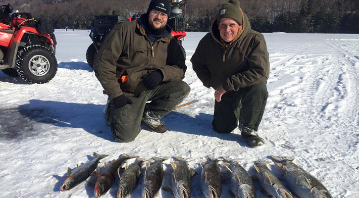 ice fish in a line near fishermen