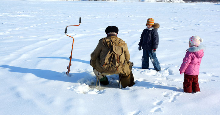 two kids near ice fisherman