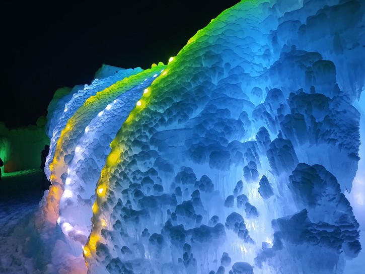 ice castles wall glowing blue and green