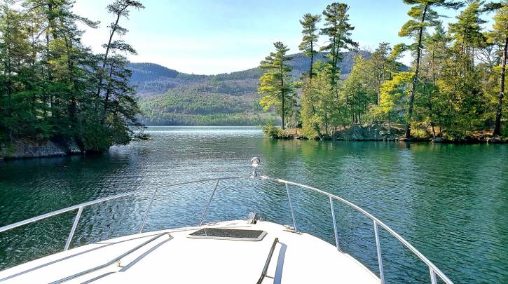 View from a boat on water with mountains and trees