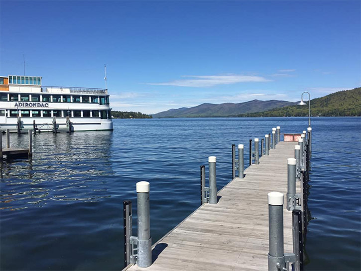 dock and steamboat on lake george on a sunny day