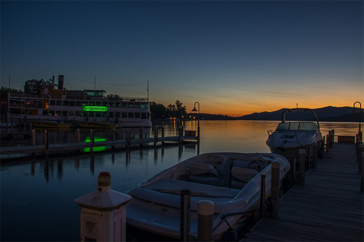 sunrise on lake george with boats in the front