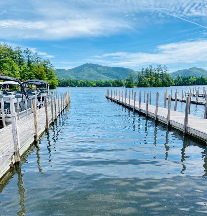 docks with view of water, boats, trees, mountain