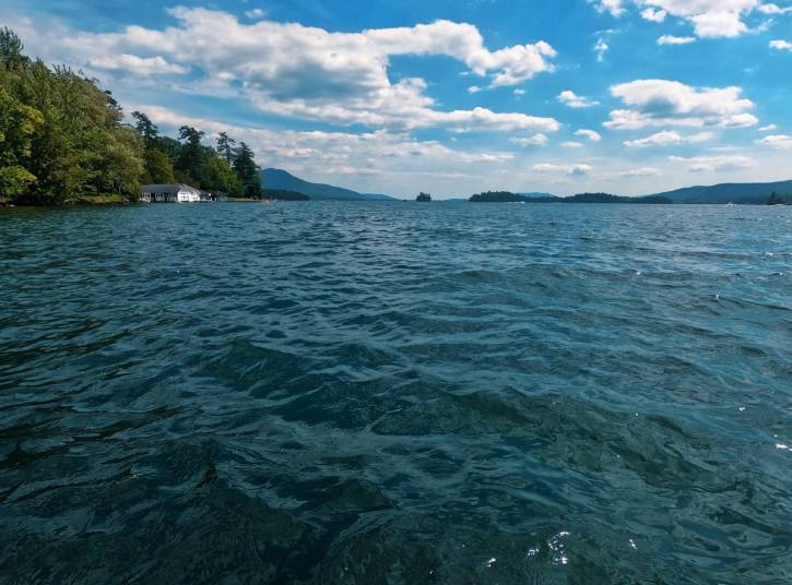 Close up of lake water with distant mountains