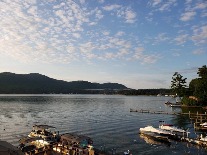 boats docked on lake at dusk