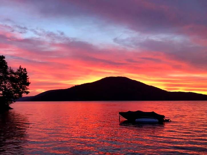 colorful sunrise over lake with mountain