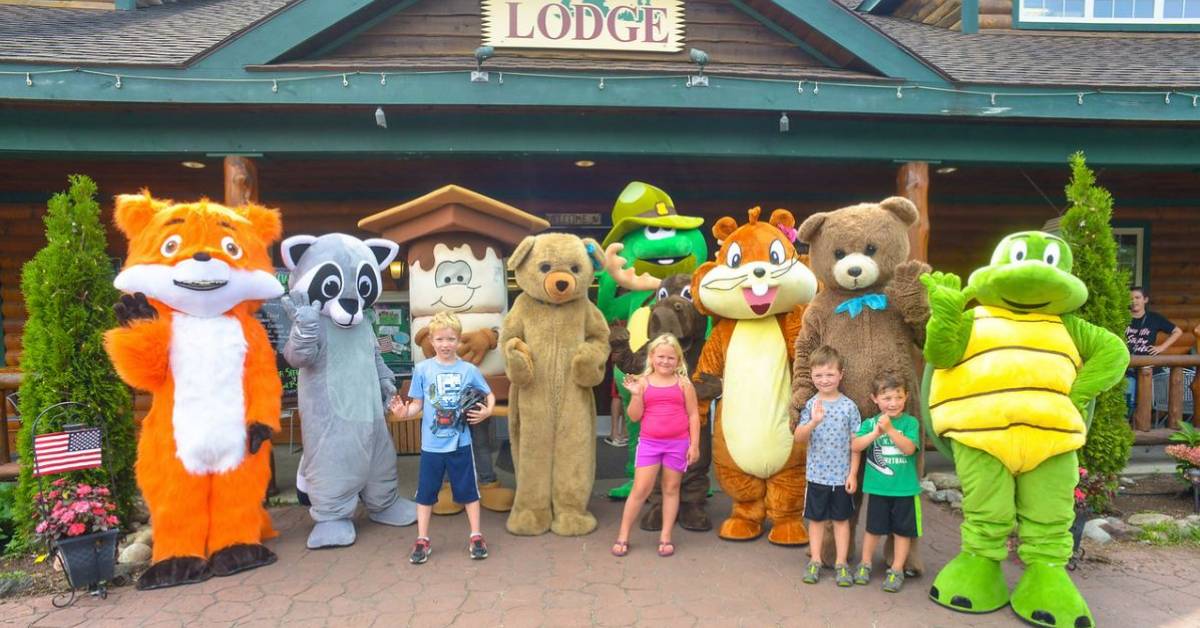 kids standing with people dressed as costumed characters