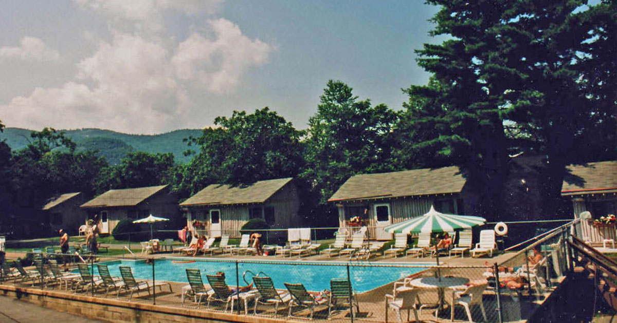 older photo of people at pool at resort