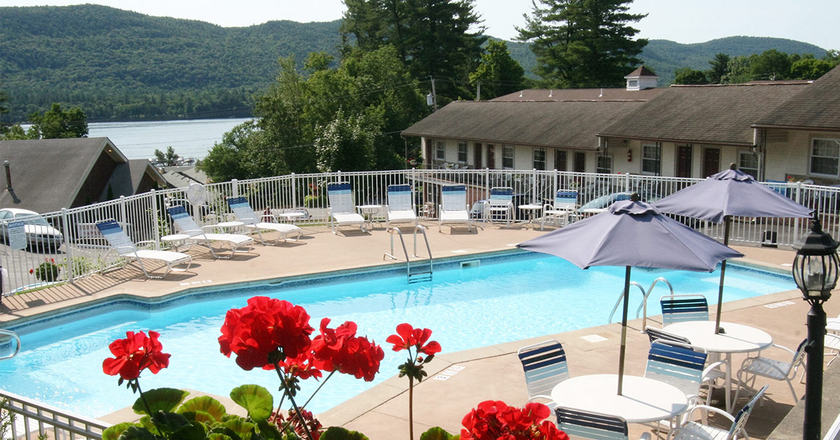 pool area and lounge chairs with lake george in the background