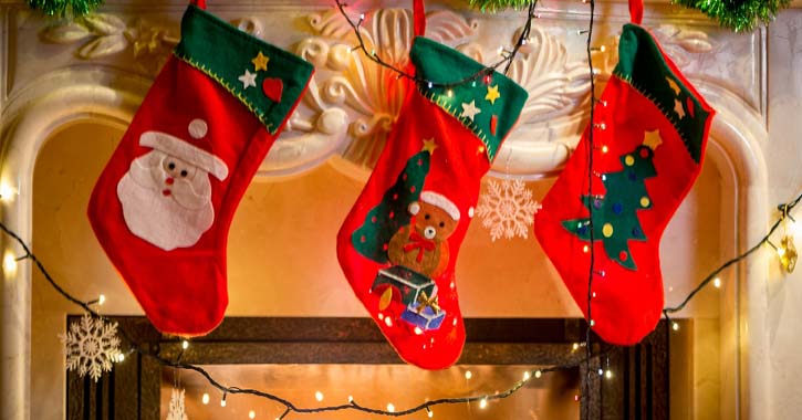 three red Christmas stockings hanging up