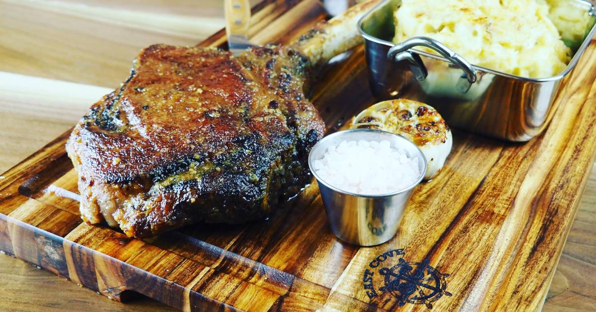 steak on a cutting board with other food