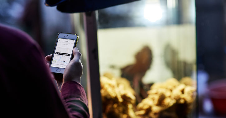 person using uber on phone