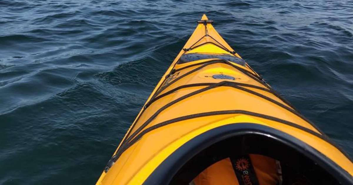 front of a yellow kayak in a lake